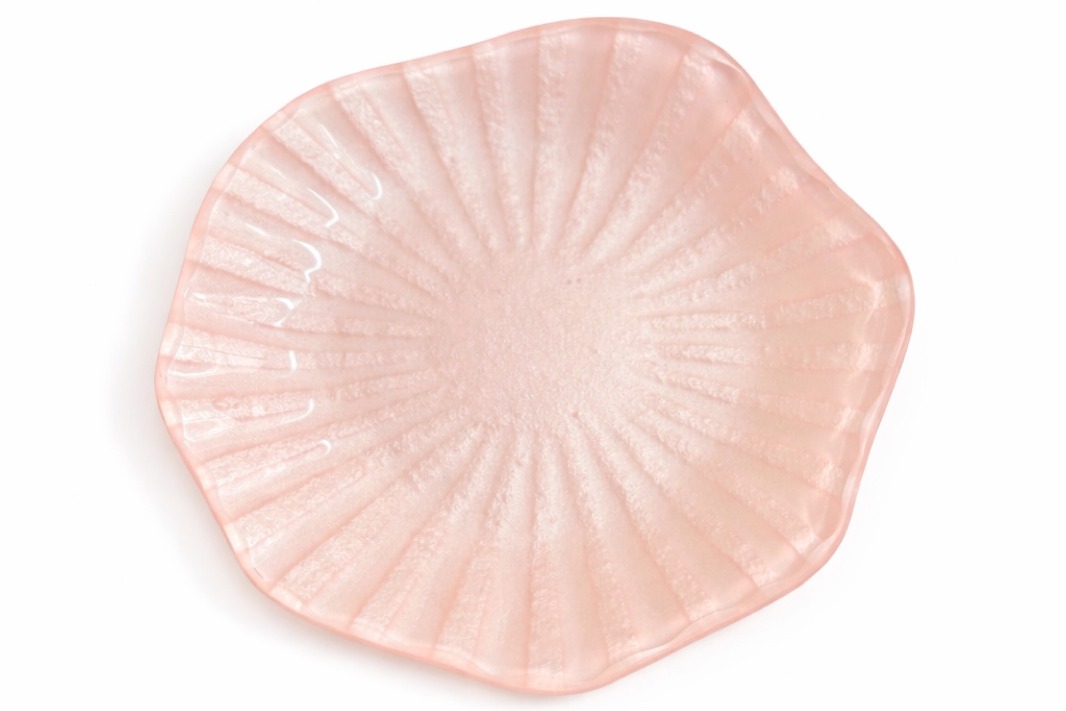 Blush-pink fluted glass trinket bowl on a clean white backdrop